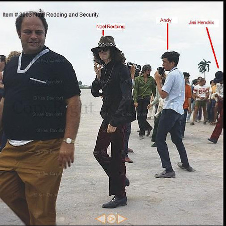 Jimi and Noel walk from helicopter to backstage area; Marshall Brevitz, rock promoter in foreground